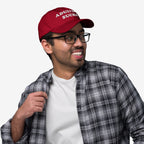 Young adult wearing an Adulting Sucks red baseball cap, embodying a relatable, vintage-inspired look. Perfect for expressing frustration with adult life, ideal for casual wear and gifting.