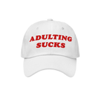 Adulting Sucks Hat with red embroidered lettering on a white cap, expressing relatable frustration with adulthood. Ideal for 