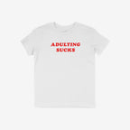 White T-shirt with bold red lettering ADULTING SUCKS, embodying humor and vintage flair, perfect for expressing the challenges of adulthood. Supports NAMI. Available in multiple styles and sizes.