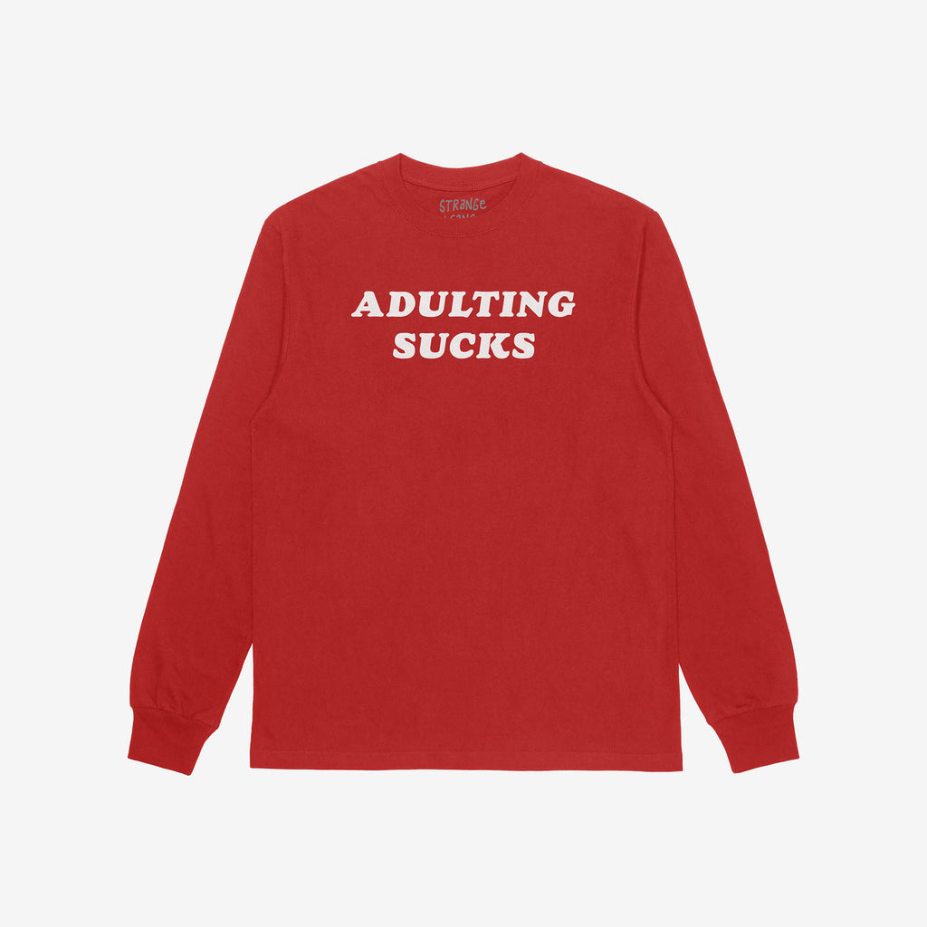 Red long-sleeve Adulting Sucks Shirt with bold white letters on chest, humorously highlighting the struggles of adult life, perfect for casual wear and self-expression. Supports NAMI through proceeds.