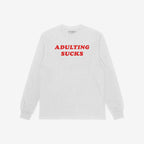White long-sleeve T-shirt with “ADULTING SUCKS” in bold red letters, offering a humorous take on adult life. Supports NAMI. Ideal for self-expression and casual comfort.