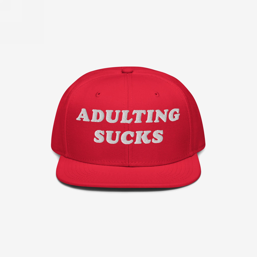 Bright red flat-bill Adulting Sucks Hat with bold white embroidered letters, ideal for expressing frustration and humor. Perfect for casual wear or as a relatable gift. Supports NAMI.