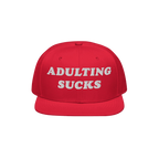 Bright red flat-bill Adulting Sucks Hat with bold white embroidered letters, ideal for expressing frustration and humor. Perf