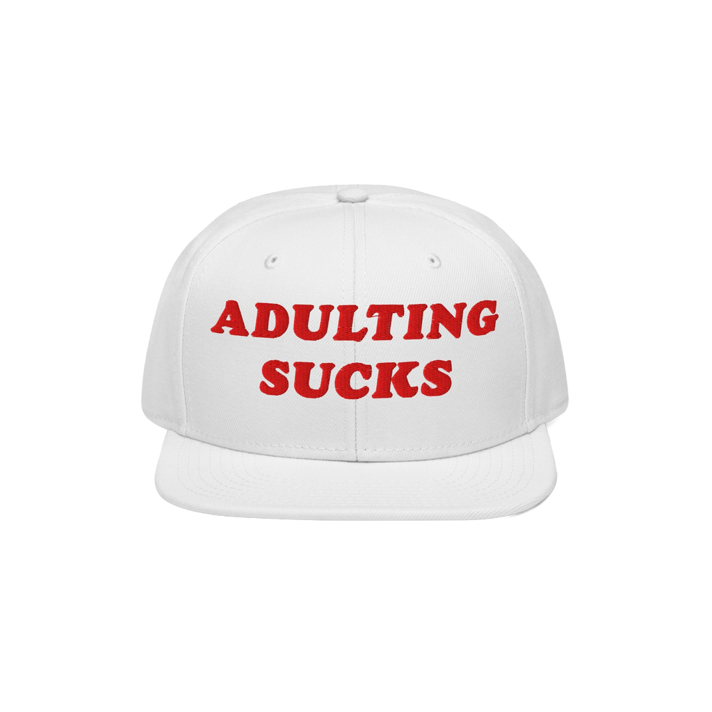 White flat-brim cap with bold red ADULTING SUCKS embroidery, reflecting a vintage-inspired, relatable style for expressing fr