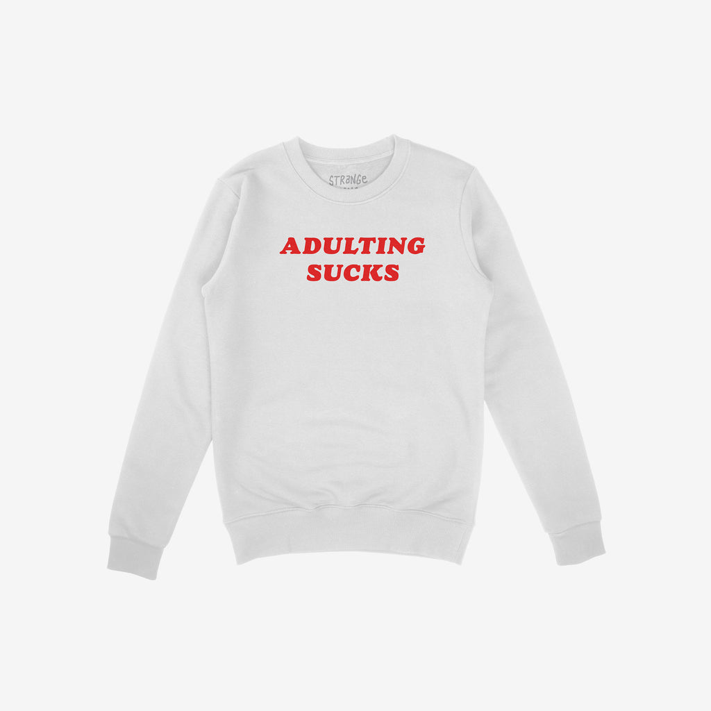 Adulting Sucks Shirt features a plain white crew-neck sweatshirt with bold red ADULTING SUCKS slogan, ribbed cuffs, and hem, offering humor and comfort for those navigating grown-up life.