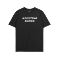 Black T-shirt featuring the slogan “ADULTING SUCKS” in white block letters, embodying humor and relatable self-expression