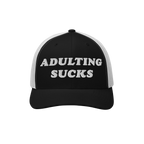 Black-and-white trucker hat with ADULTING SUCKS embroidered on front. Features white mesh panels, curved black bill. Ideal fo