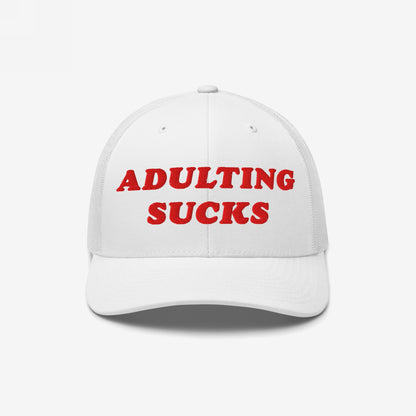 White mesh-back trucker hat with bold red embroidery stating “ADULTING SUCKS,” capturing a candid sentiment for millennials and Gen Z, perfect for casual wear and expressing honest frustration.