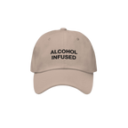 Alcohol Infused Hat: A tan baseball-style cap with bold black embroidery reading “ALCOHOL INFUSED,” embodying edgy humor 