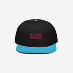 Alcohol Infused Hat: A bold snapback with 'ALCOHOL INFUSED' in magenta on a black crown, featuring a turquoise flat brim, reflecting a playful, rebellious spirit.