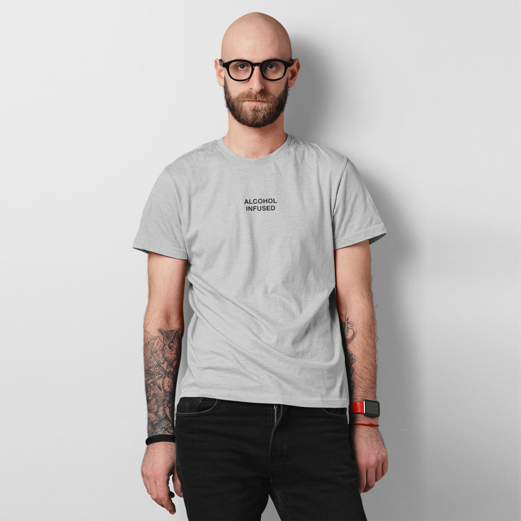 Man wearing an Alcohol Infused T-shirt, showcasing a bold statement tee with a minimalist aesthetic. The design reflects a carefree, unapologetic lifestyle, aligning with the store's ethos of individuality and equality.