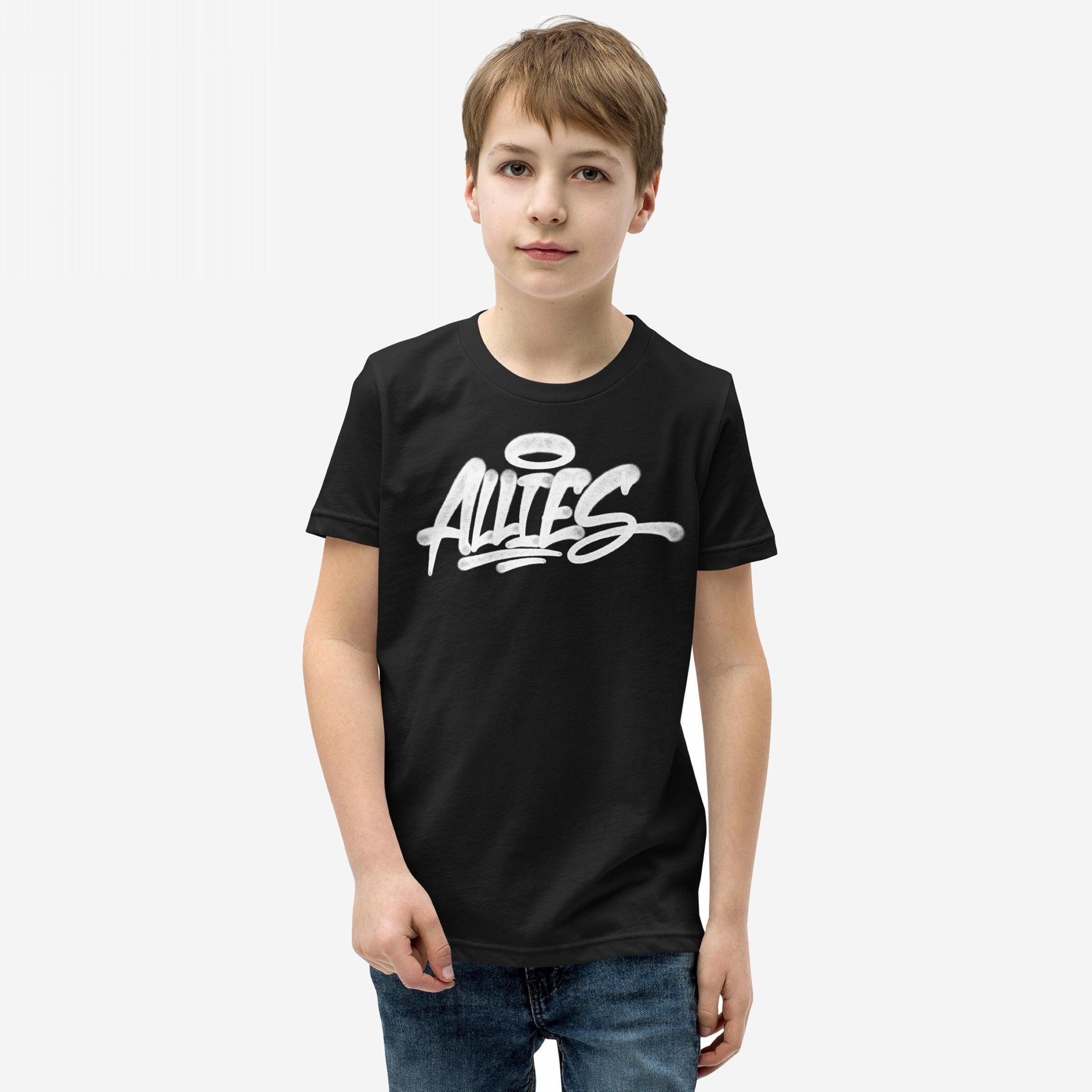 Young boy wearing the Allies Handstyle T-shirt, featuring a graffiti-style ALLIES graphic with a halo. A nod to solidarity and allyship, paired with blue jeans, embodying unity and support.