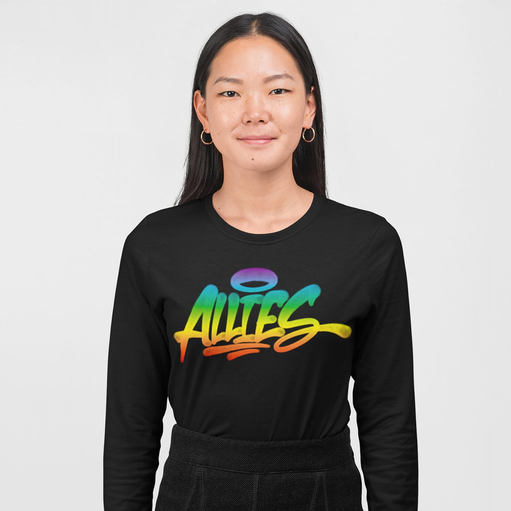 Woman wearing Allies Rainbow Handstyle T-shirt, featuring graffiti-style Allies text in rainbow gradient, paired with dark trousers and hoop earrings, symbolizing LGBTQ+ solidarity and inclusion.