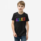 Young boy wearing the Allies Rainbow T-shirt, featuring ALLIES in rainbow letters on a black tee, symbolizing LGBTQ+ support and community solidarity, paired with blue jeans.