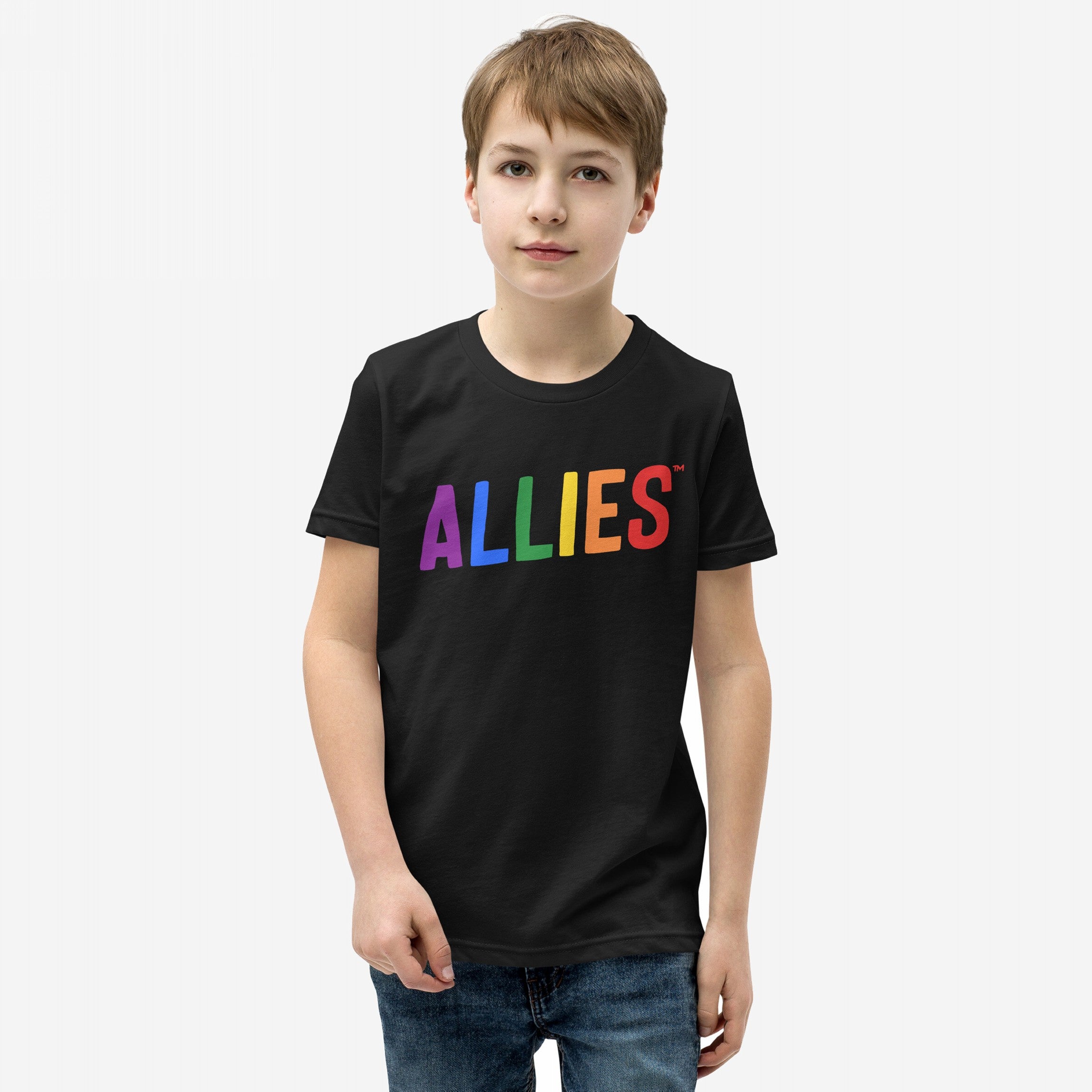 Young boy wearing the Allies Rainbow T-shirt, featuring ALLIES in rainbow letters on a black tee, symbolizing LGBTQ+ support and community solidarity, paired with blue jeans.