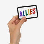 Hand holding Allies Rainbow Patch with ALLIES stitched in rainbow colors on a white background, symbolizing LGBTQ+ support and allyship.