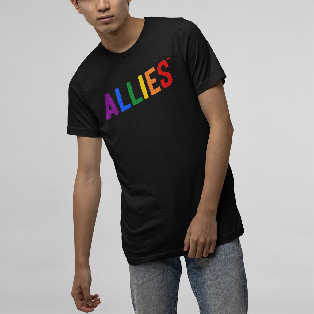 Person wearing the Allies Rainbow T-shirt, featuring ALLIES in rainbow colors, paired with light-wash jeans, embodying a bold statement of LGBTQ+ support and allyship.