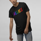 Person wearing the Allies Rainbow T-shirt, featuring ALLIES in rainbow colors, paired with light-wash jeans, embodying a bold statement of LGBTQ+ support and allyship.