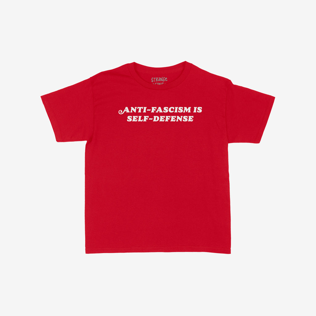 Anti-Fascism Is Self-Defense Women's Baby Tee with bold white text on red cotton. Retro-inspired design promotes standing up for beliefs. Brand name subtly visible at the back.