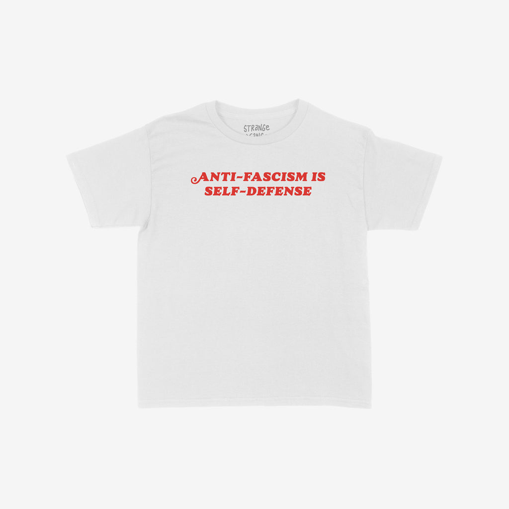 Anti-Fascism Is Self-Defense Women's Baby Tee featuring bold red slogan on a plain white shirt, embodying a direct stance against fascism with retro-inspired typography. Ideal for making a strong statement.