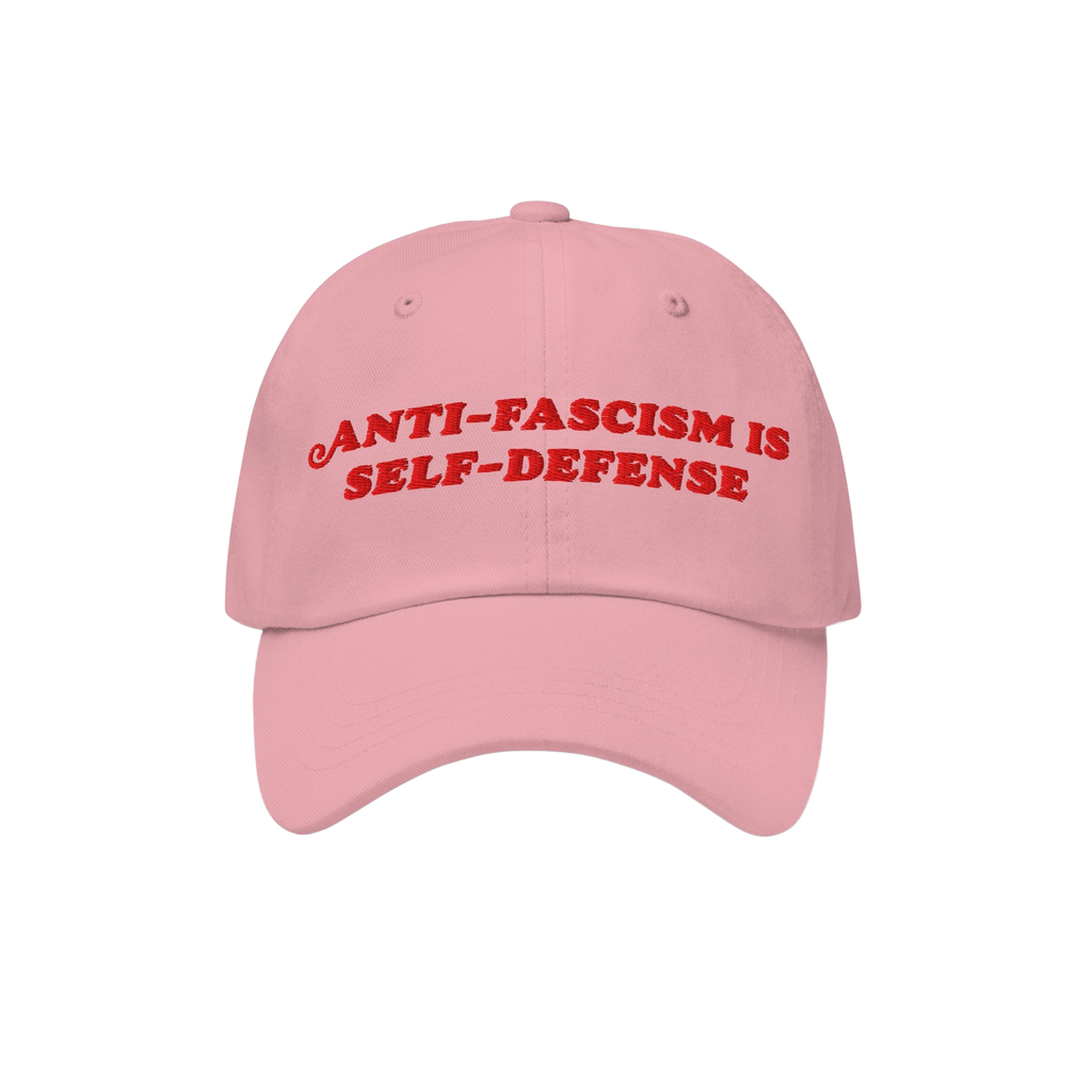 Light-pink Anti Fascism Is Self Defense Hat with bold red embroidery, embodying a retro activist style. Ideal for rallies or 
