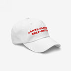 White baseball cap featuring bold red embroidery with the text ANTI-FASCISM and SELF-DEFENSE, embodying activist spirit and support for human rights causes. Ideal for protests and rallies.