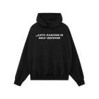 Black pullover hoodie featuring the bold slogan “ANTI-FASCISM IS SELF-DEFENSE” in white. The Anti Fascism Is Self Defense
