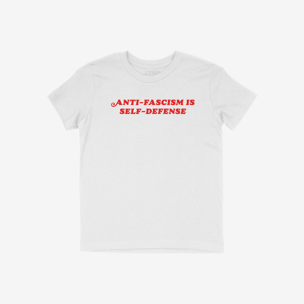 White T-shirt featuring bold red text, “ANTI-FASCISM IS SELF-DEFENSE,” encapsulates a powerful message, merging activism and vintage style, supporting justice and human rights.