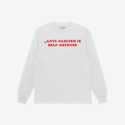 Anti-Fascism Is Self-Defense T-shirt features bold red slogan on a plain white long-sleeve, embodying resistance and advocacy for equality with a vintage-inspired design.