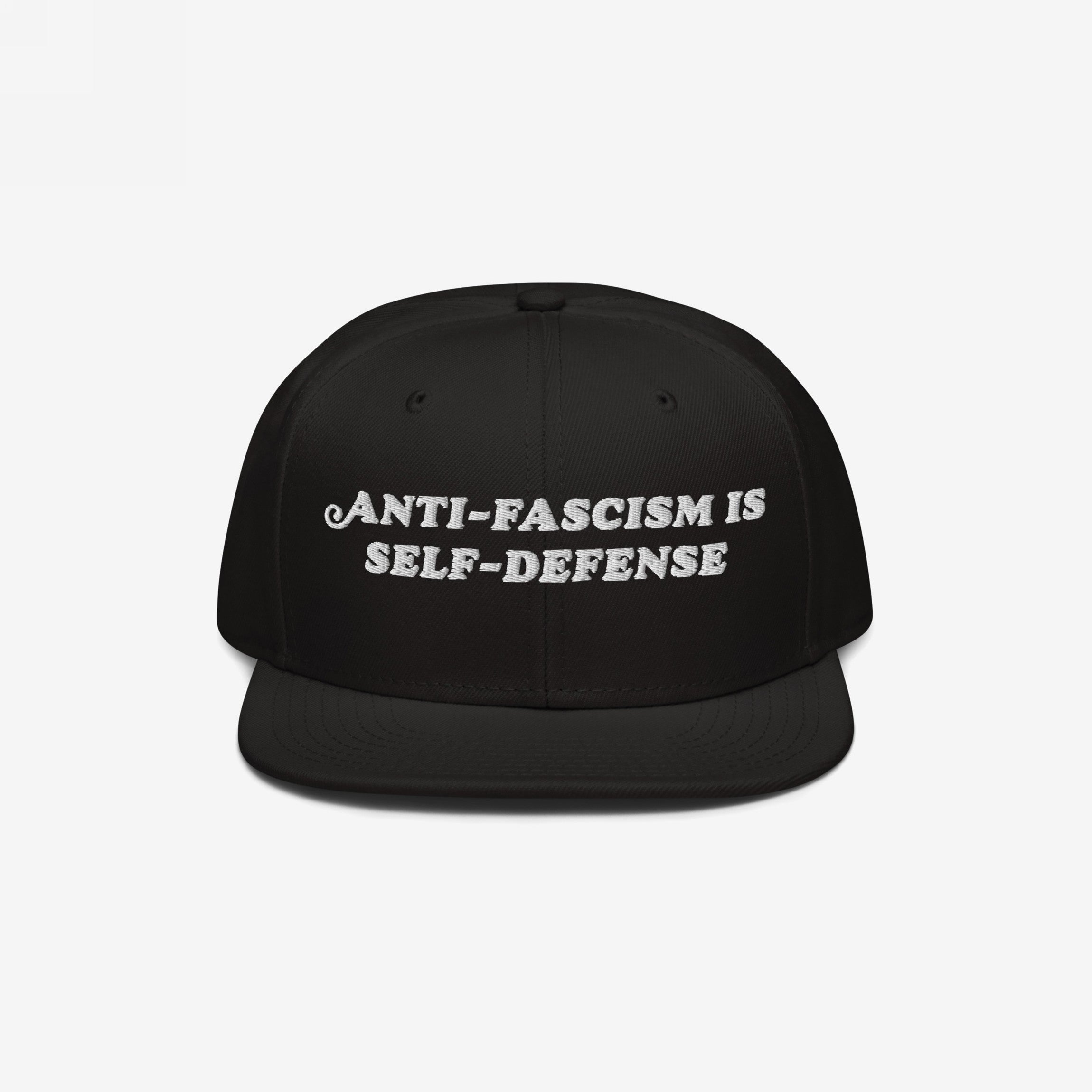 Black snap-back cap with the bold, white embroidered text ANTI-FASCISM IS SELF-DEFENSE, ideal for activists advocating human rights and equality, supporting ACLU.