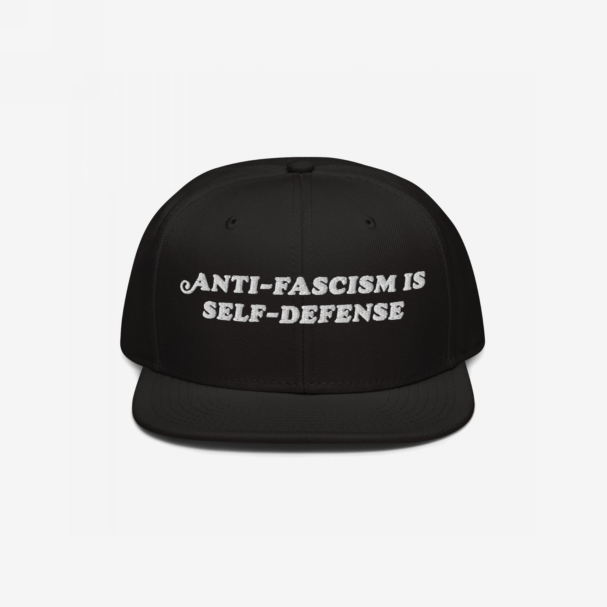 Black flat-brimmed snapback hat, “Anti-Fascism Is Self-Defense” embroidered boldly in white. A statement piece for those who resist.
