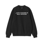 Black crewneck sweatshirt with “ANTI-FASCISM IS SELF-DEFENSE” in white on chest, reflecting activism and justice. Include