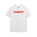 Anti Fascism Is Self Defense Shirt with bold red lettering on a plain white T-shirt, featuring a small inside collar label, e