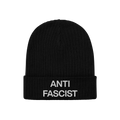 Black rib-knit beanie with “ANTI FASCIST” embroidered in white on the cuff, representing the Anti-Fascist Classic Hat—a