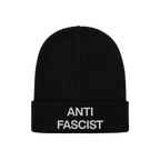 Black rib-knit beanie with “ANTI FASCIST” embroidered in white on the cuff, representing the Anti-Fascist Classic Hat—a
