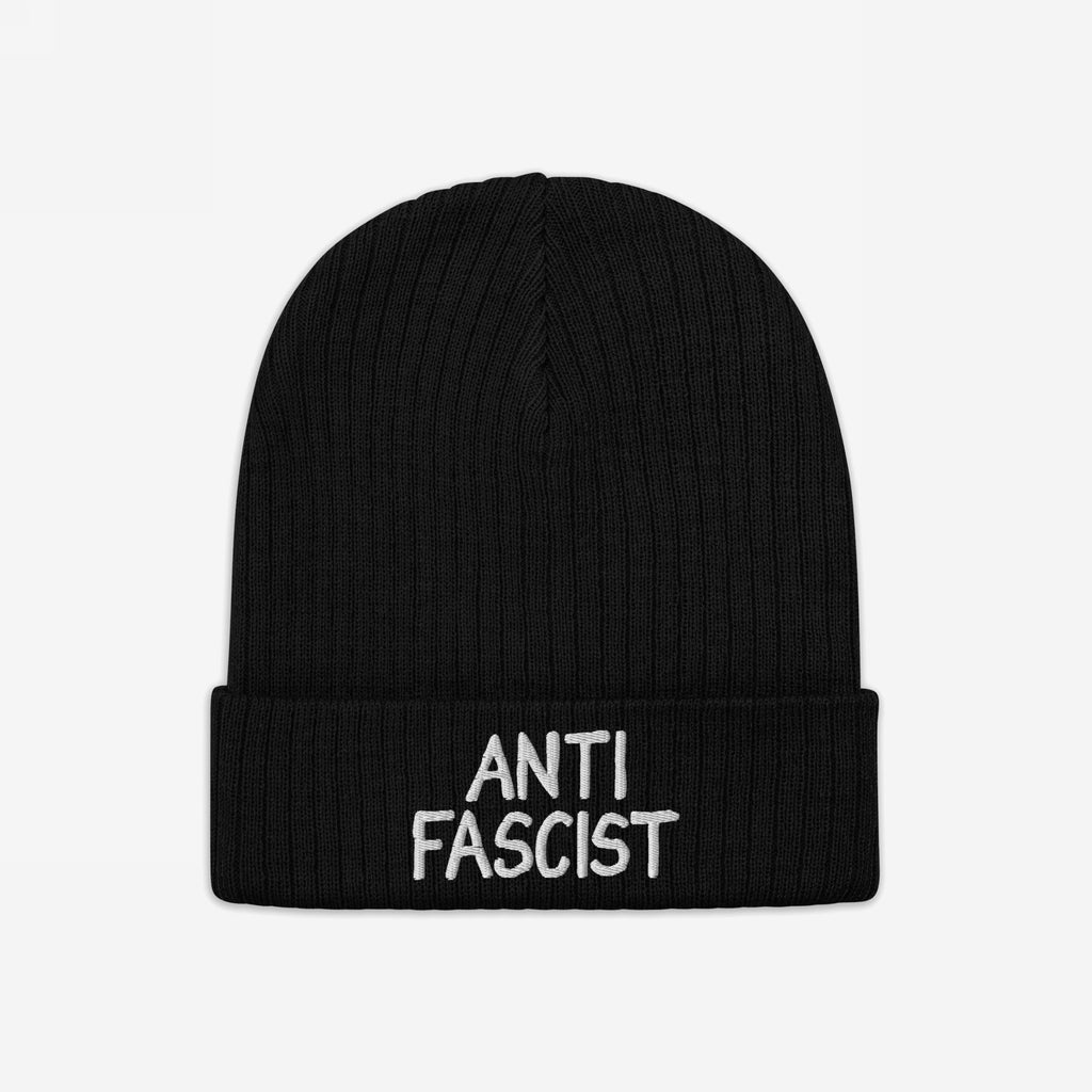 Black rib-knit beanie with ANTI FASCIST embroidered in white on the cuff, symbolizing resistance. Unisex design, ethically crafted, and supporting the ACLU, blending activism with everyday style.