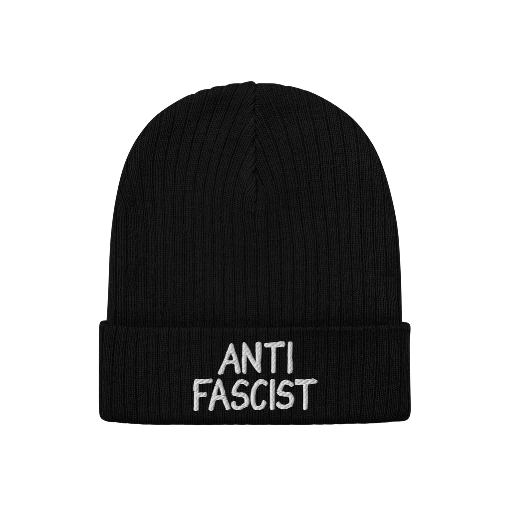 Black rib-knit beanie with ANTI FASCIST embroidered in white on the cuff, symbolizing resistance. Unisex design, ethically cr