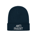 Dark navy-blue ribbed knit beanie with ANTI FASCIST embroidered in white on the cuff, embodying revolutionary style and ethic
