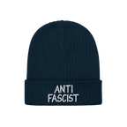 Dark navy-blue ribbed knit beanie with ANTI FASCIST embroidered in white on the cuff, embodying revolutionary style and ethic