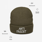 Anti Fascist Hat with ANTI FASCIST embroidery on olive-green, rib-knit, double-layered cuffed beanie made from recycled polyester, highlighting ethical, unisex design for style-conscious activism. Benefits ACLU.