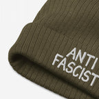 Close-up of the Anti Fascist Hat, an olive-green rib-knit beanie with ANTI FASCIST embroidered in white on the cuff, embodying style and activism against fascism.