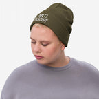 A person wearing the Anti Fascist Hat, an olive green rib-knit beanie with ANTI FASCIST embroidered in white, embodies defiance and style. Paired with a gray sweatshirt, it signifies bold activism.