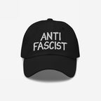 Black Anti Fascist Hat featuring “ANTI FASCIST” embroidered in white on the front. This unisex cap combines activism with style, ethically made to support the fight against fascism.