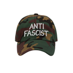 Woodland-camo baseball cap with ANTI FASCIST in white embroidery, combining style with activism. Ethically made, unisex, desi