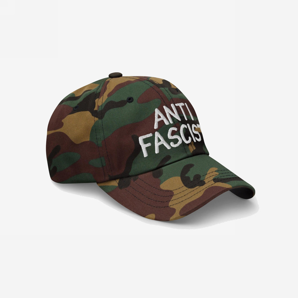 Anti Fascist Hat: A six-panel, curved-brim cap with woodland camouflage and ANTI FASCIST in white embroidery, combining activism with style, crafted for comfort and ethical integrity.