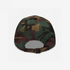 Rear view of the Anti-Fascist Classic Hat in woodland camouflage, showcasing its adjustable fabric strap, metal buckle, six-panel stitching, and ventilation eyelets, embodying a bold, resistance-driven style.
