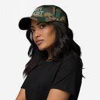 A person wears the Anti Fascist Hat, featuring a camouflage pattern and ANTI FASCIST text, highlighting its bold stance. They pair it with a simple black T-shirt, embodying a message of resistance.