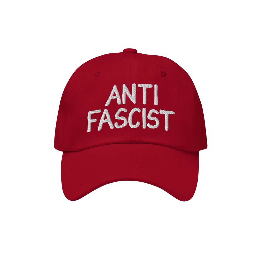 Anti Fascist Hat featuring ANTI FASCIST in white hand-drawn embroidery on a red baseball-style cap, embodying a stylish stand