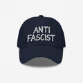 Navy-blue Anti Fascist Hat with ANTI FASCIST embroidered in white, symbolizing resistance and style. Unisex and ethically crafted, supporting ACLU, embodying a stand against fascism with everyday comfort and flair.