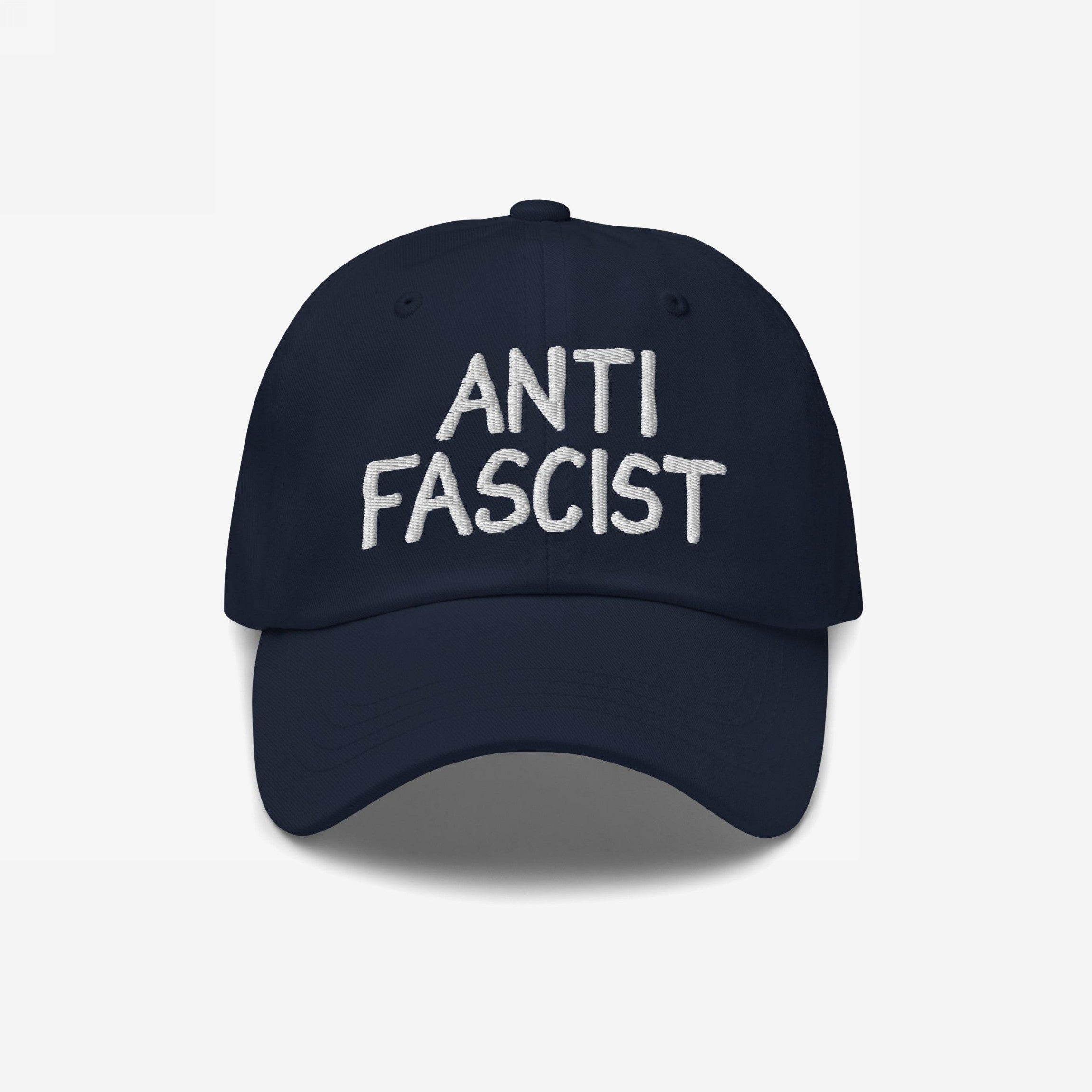 Navy-blue Anti Fascist Hat with ANTI FASCIST embroidered in white, symbolizing resistance and style. Unisex and ethically crafted, supporting ACLU, embodying a stand against fascism with everyday comfort and flair.